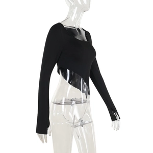 Detail of the asymmetrical hem and slim fit long sleeve black cropped top for women