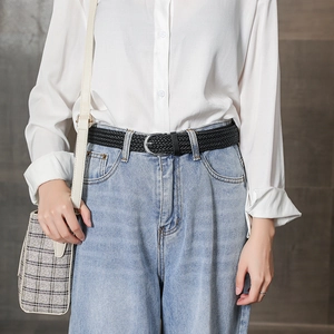 Women's black braided twist belt with silver buckle on blue jeans for fashion styling