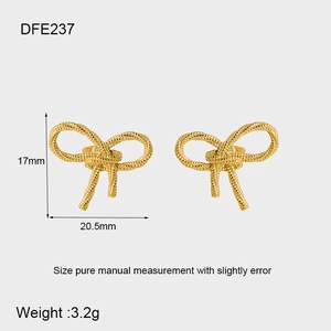 Detail view of 18K gold bow stud earrings showing woven texture and 17mm x 20.5mm dimensions