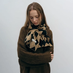 Winter two-tone knitted scarf with black and camel rhombus pattern on a fashion model
