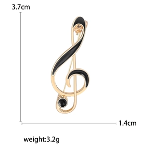 Golden musical note brooch with black enamel, measuring 3.7cm height and 1.4cm width
