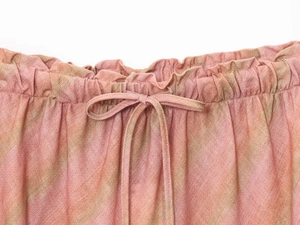 Detail of pink linen midi skirt showing elastic waistband and adjustable drawstring tie