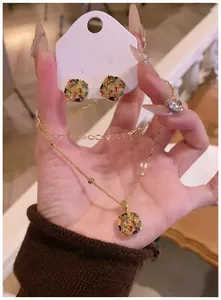 Close-up of gold-plated jewelry set featuring colorful rectangular zircon stones