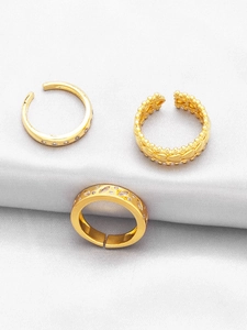 Detailed view of three stackable gold rings featuring zirconia hearts and adjustable bands
