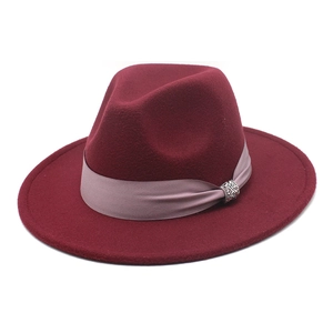Detailed shot of burgundy wool fedora hat with pink satin band and rhinestone buckle
