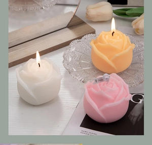 Detailed view of rose-shaped scented candles in white, yellow, and pink colors