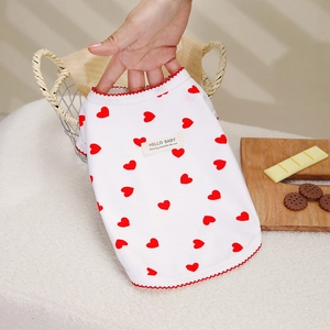 Close-up of lightweight dog vest with red heart print and delicate red scalloped edges