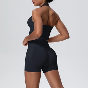 Detail of breathable black seamless yoga set featuring halter neck top and high waist shorts