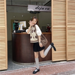 Stylish leopard print crossbody tote bag paired with preppy knit vest and pleated skirt