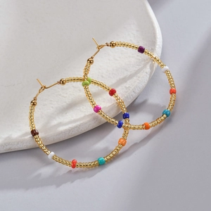 Chic 14K gold plated titanium hoop earrings with colorful rainbow beads on white tray