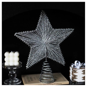 Macro shot of silver glitter Christmas star topper with spiral base on a gift display