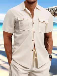 Detail of men's beige waffle knit shirt showing textured fabric and wooden buttons
