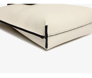 Close-up of pebble grain white genuine leather with fine black edge oil finish