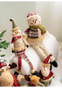 Detail of plush Santa, Snowman and Reindeer dolls with knitted legs for Christmas decor