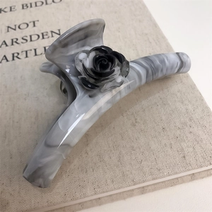 Elegant ice grey marble acetate hair claw clip with a black camellia flower for women