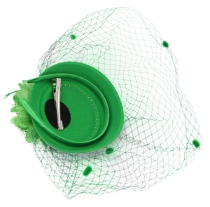 Detail of green fascinator hat with feather flower, mesh veil and metal hair clip