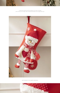 Detail of red Christmas stocking with 3D snowman hanging by a fireplace for festive decor