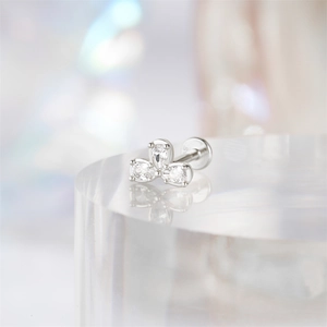 Close-up of a s925 silver three-petal flower earring with clear gemstones on a pedestal