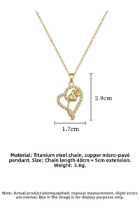 Close-up of heart-shaped pendant with golden rose center and micro-pave crystals