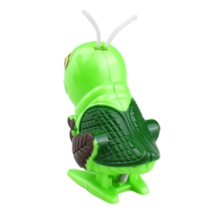 Funny green wind-up grasshopper toy made of plastic with realistic wings and clockwork