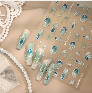 Detail of 3D embossed floral nail stickers with orchid designs and mint green patterns