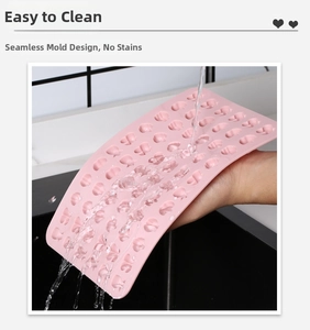 Detail showing pink heart-shaped silicone mold being rinsed under water for easy cleaning