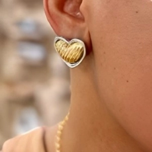 French vintage heart earrings in gold and silver mixed metal finish worn by a model