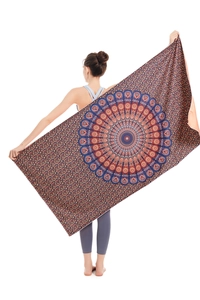 Detail of a large microfiber beach towel with vintage orange and blue mandala patterns
