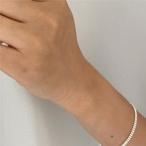 Close-up of a minimalist S925 sterling silver beaded chain bracelet on a wrist