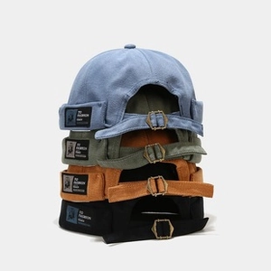 Vertical stack of four colorful docker hats with FD FASHION Studio woven labels