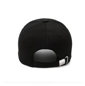 Detail view of adjustable silver metal buckle on black cotton baseball cap back