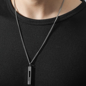 Minimalist silver stainless steel rectangular column pendant necklace worn on black t-shirt