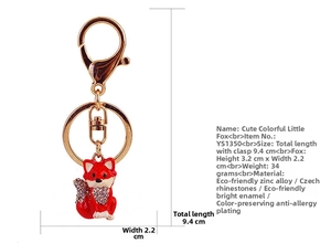 Close-up of red fox keychain with Czech rhinestones and colorful oil drip finish