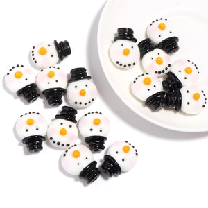 Macro shot of snowman glass beads for DIY jewelry making on white background