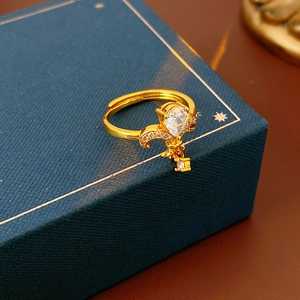 Macro shot of vintage gold ring with pear-shaped zircon and fleur-de-lis details