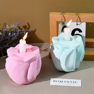 Detailed view of rose petal shaped candle holders in pink and light blue matte finish