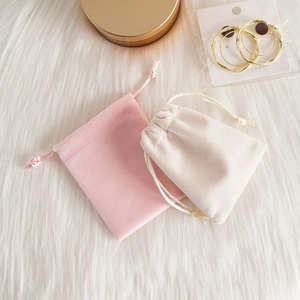 Detail of pink and beige velvet drawstring pouches for jewelry storage and gifting