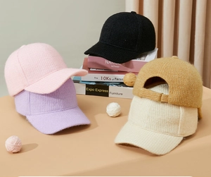 Close-up of five knitted baseball caps in various colors with a metal adjustment buckle