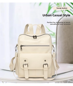 Detail of creamy white faux leather backpack featuring double buckle flap and side pockets