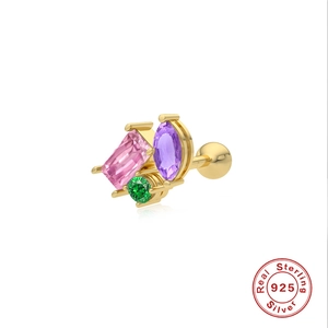 Detailed macro of gold S925 sterling silver stud with pink, purple and green gemstones