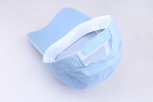 Detail view of light blue cotton baseball cap showing adjustable velcro strap and inner lining