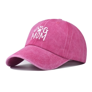 Close-up of pink washed denim dog mama baseball cap with white embroidered paw print