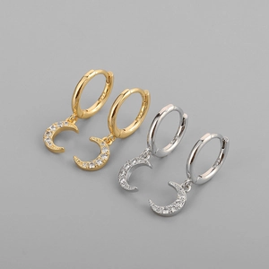 Close-up of gold and silver S925 sterling silver crescent moon earrings with cubic zirconia