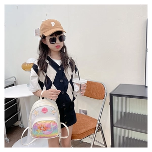 Little girl wearing a white sequin mermaid backpack with 3D shell and starfish details