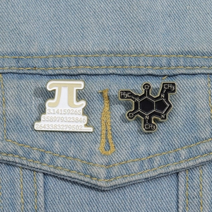 Macro detail of enamel pins featuring Pi symbol and caffeine chemical structure on denim