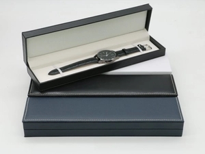 Detail of rectangular PU leather watch boxes with fine white stitching and cream interior
