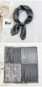 Detail of square silk scarf with paisley and houndstooth pattern in grey tones