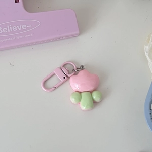 Close-up of pink flower keychain with shiny resin finish and pink lobster clasp