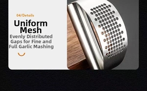 Close-up of stainless steel garlic press with uniform round squeeze holes on wood