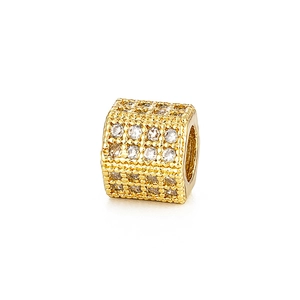 Primer plano de cuenta hexagonal dorada con circonitas brillantes para joyería artesanal DIY